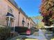 Beautiful row of brick townhomes with manicured landscaping, creating a charming neighborhood street view at 6980 Roswell Rd # E1, Atlanta, GA 30328