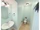Small half bathroom with pedestal sink and toilet at 6980 Roswell Rd # E1, Atlanta, GA 30328