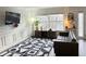 Cozy living room with trendy black and white wallpaper, a modern rug, and a comfortable leather couch at 6980 Roswell Rd # E1, Atlanta, GA 30328