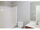 Bright bathroom features a bathtub and shower combination, toilet, and vanity with a mirror at 910 Lakeside Ct, Loganville, GA 30052