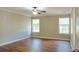 Bright bedroom with two windows, a ceiling fan and wood-look laminate flooring at 910 Lakeside Ct, Loganville, GA 30052