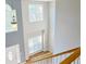 Open foyer view from the top of the stairs with natural lighting and hardwood floors at 910 Lakeside Ct, Loganville, GA 30052