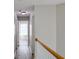 Hallway with neutral paint, hardwood floors and natural lighting at 910 Lakeside Ct, Loganville, GA 30052