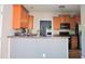 Well-lit kitchen with wood cabinets, sleek countertops, and stainless steel appliances at 910 Lakeside Ct, Loganville, GA 30052