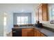 Bright kitchen area with stainless steel dishwasher and wood-look flooring at 910 Lakeside Ct, Loganville, GA 30052