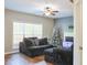 Cozy living room features hardwood floors, ceiling fan, and natural light from the window at 910 Lakeside Ct, Loganville, GA 30052