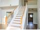 Well-lit staircase with wooden treads and white risers and banister at 910 Lakeside Ct, Loganville, GA 30052