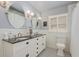 Stylish bathroom featuring a double vanity with dark countertop, dual mirrors, and patterned tile flooring at 2850 Gant Quarters Dr, Marietta, GA 30068