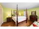 Bedroom featuring a four-poster bed, hardwood floors, and a green painted walls at 2850 Gant Quarters Dr, Marietta, GA 30068