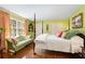 Bedroom with hardwood floors, four poster bed, green walls, decorative pillows and a large window at 2850 Gant Quarters Dr, Marietta, GA 30068