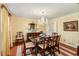 Bright dining room with chandelier, wallpaper, rich wood furniture, and natural light at 2850 Gant Quarters Dr, Marietta, GA 30068