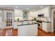 Bright kitchen features white cabinetry, stainless steel appliances, island, and hardwood floors at 2850 Gant Quarters Dr, Marietta, GA 30068
