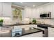 Close-up of the kitchen featuring white cabinets, granite countertops, stainless appliances, and subway tile backsplash at 2850 Gant Quarters Dr, Marietta, GA 30068
