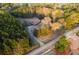 A birds eye view of home in the trees with a long driveway and spacious front yard in a lush, wooded area at 3856 Egypt Rd, Snellville, GA 30039