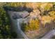 Aerial view of a ranch-style home with mature trees, long driveway, and spacious front yard in a lush, wooded area at 3856 Egypt Rd, Snellville, GA 30039