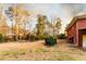 A spacious backyard featuring tall trees and a well-maintained lawn, adjacent to a brick home at 3856 Egypt Rd, Snellville, GA 30039