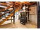 Basement with staircase, wood-burning stove, laundry area, and concrete walls at 3856 Egypt Rd, Snellville, GA 30039