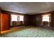 Bedroom with wood paneling, two windows letting in natural light, and decorative carpet at 3856 Egypt Rd, Snellville, GA 30039