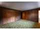 Bedroom with wood-paneled walls, a closet, and entrance to what looks like a bathroom at 3856 Egypt Rd, Snellville, GA 30039