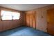 This bedroom features blue carpet and light-colored wood walls and trim at 3856 Egypt Rd, Snellville, GA 30039