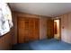This bedroom features blue carpet and light-colored wood walls and trim at 3856 Egypt Rd, Snellville, GA 30039