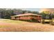 Spacious home featuring a lush green yard, brick exterior, and charming curb appeal at 3856 Egypt Rd, Snellville, GA 30039