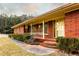 Welcoming brick porch with a cozy sitting area, complemented by lush landscaping and a classic design at 3856 Egypt Rd, Snellville, GA 30039