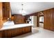 Bright kitchen with wood paneling, a breakfast bar, and view into an adjacent room at 3856 Egypt Rd, Snellville, GA 30039