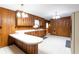 Spacious kitchen featuring wood paneling, ample counter space, and vintage light fixtures at 3856 Egypt Rd, Snellville, GA 30039