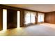 Bright living room with generous natural light, wood-paneled walls, and pristine carpeted flooring at 3856 Egypt Rd, Snellville, GA 30039