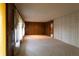 Open living room with neutral carpet and paneled walls offering a blank canvas for personalized design at 3856 Egypt Rd, Snellville, GA 30039