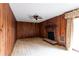 Cozy living room featuring wood-paneled walls and a brick fireplace with mantel at 3856 Egypt Rd, Snellville, GA 30039