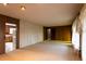 Inviting living room with a blend of brick and paneled walls and neutral carpet providing a cozy ambiance at 3856 Egypt Rd, Snellville, GA 30039