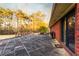 Expansive patio with brick home, surrounded by lush trees, and offering outdoor living at 3856 Egypt Rd, Snellville, GA 30039