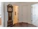 Hallway with grandfather clock showing the bathroom with blue and white nautical shower curtain at 539 Creekview Overlook, Stockbridge, GA 30281