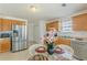 Sunlit eat-in kitchen features stainless appliances, wood cabinets and a breakfast nook at 539 Creekview Overlook, Stockbridge, GA 30281