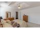 Bright main bedroom with tray ceilings, ceiling fan, and neutral decor at 539 Creekview Overlook, Stockbridge, GA 30281