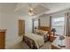 Cozy main bedroom with tray ceilings, ceiling fan, and neutral decor at 539 Creekview Overlook, Stockbridge, GA 30281