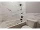 Bathroom featuring a soaking tub with marble-like tile surround, and a modern shower head at 2921 Lenox Ne Rd # 113, Atlanta, GA 30324
