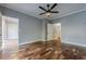 Spacious bedroom with hardwood floors, a ceiling fan, and an ensuite bathroom at 2921 Lenox Ne Rd # 113, Atlanta, GA 30324