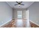 Bedroom featuring hardwood floors, a ceiling fan, and a large window at 2921 Lenox Ne Rd # 113, Atlanta, GA 30324