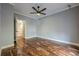 Spacious bedroom with hardwood floors, a ceiling fan, and an ensuite bathroom at 2921 Lenox Ne Rd # 113, Atlanta, GA 30324