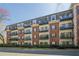 Brick building with multiple balconies and manicured landscaping at 2921 Lenox Ne Rd # 113, Atlanta, GA 30324