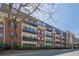 Exterior view of the condo building with balconies, brick facade and a covered entry at 2921 Lenox Ne Rd # 113, Atlanta, GA 30324