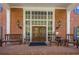 The building entrance features wood benches, brick facade and lantern sconces at 2921 Lenox Ne Rd # 113, Atlanta, GA 30324