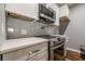 Close-up of modern stainless steel range and microwave in updated kitchen at 2921 Lenox Ne Rd # 113, Atlanta, GA 30324