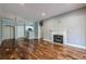 Bright living room with fireplace, hardwood floors, and open access to the kitchen at 2921 Lenox Ne Rd # 113, Atlanta, GA 30324