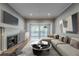 Bright living room with fireplace, modern decor, and sliding glass doors to the outside at 2921 Lenox Ne Rd # 113, Atlanta, GA 30324