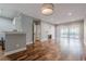 Spacious living room with hardwood floors, fireplace, and kitchen view at 2921 Lenox Ne Rd # 113, Atlanta, GA 30324