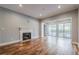 Open living space with hardwood floors, fireplace, and sliding doors to patio at 2921 Lenox Ne Rd # 113, Atlanta, GA 30324